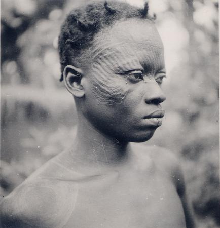 Portrait of an Igbo man with Ichi facial scarification and plaited hair.