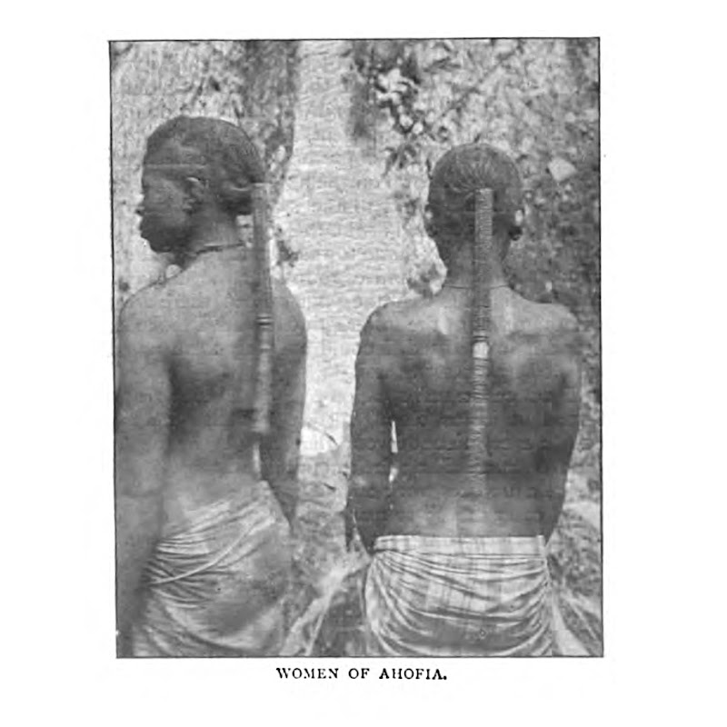 A photograph depicting two Ohafia women from behind with braids extending down their backs.